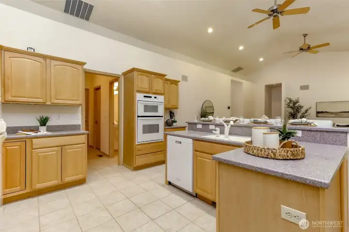 Room off kitchen is where you will find a large laundry area, walk in pantry, extra bathroom, & door to garage.