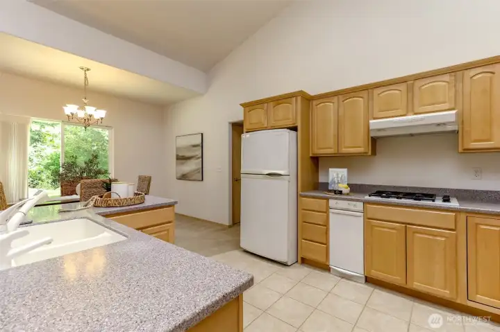 Trash compactor conveniently placed next to stovetop.