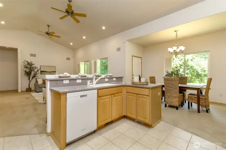Dishwasher, prep area, sink, all looking out to guests or family. Also central vac to the right.