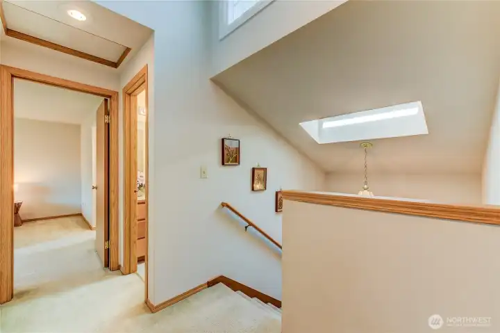 Here's the upper landing/hallway showing the door to the primary bedroom and the hall bathroom on the right.  The primary bath is inside the primary bedroom inside on the right (can't see it in this pic but it's there!)