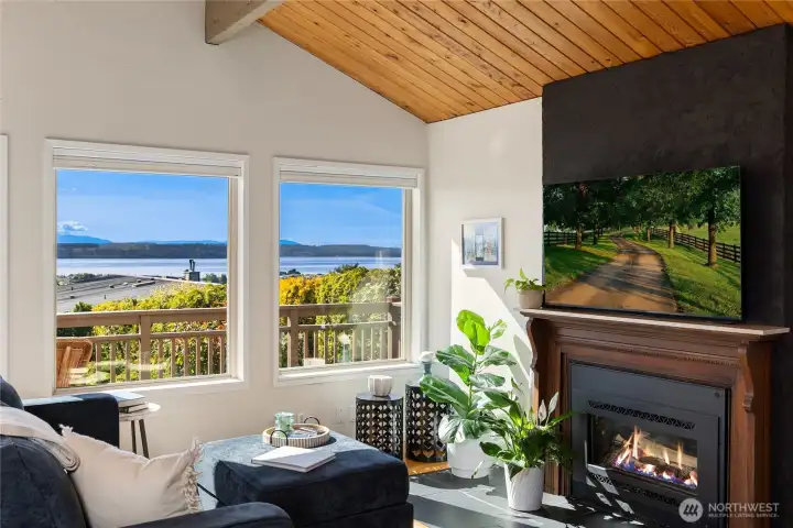 The light-filled living space features expansive windows that frame the magnificent views, creating the perfect place to relax by the fireplace and soak in the beauty of the Pacific Northwest. The light-filled living space features expansive windows that frame the magnificent views, creating the perfect place to relax by the fireplace and soak in the beauty of the Pacific Northwest.