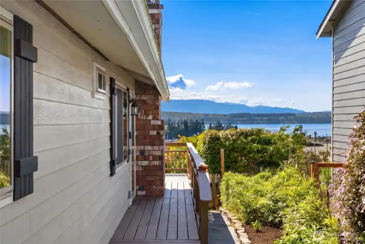 As you approach the front door, glimpses of the stunning Hood Canal and Olympic Mountain views immediately draw you in, setting the tone for the peaceful beauty that awaits inside. As you approach the front door, glimpses of the stunning Hood Canal and Olympic Mountain views immediately draw you in, setting the tone for the peaceful beauty that awaits inside.