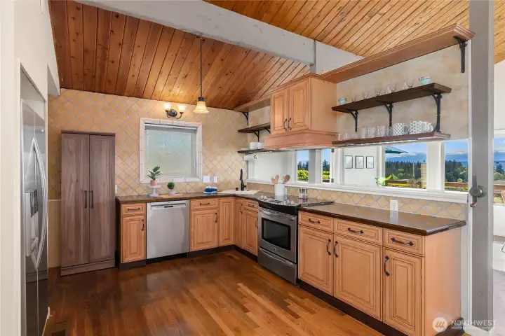 The kitchen cabinetry is complemented by under-cabinet lighting, adding warmth, ambiance, and practical task lighting to the space. The kitchen cabinetry is complemented by under-cabinet lighting, adding warmth, ambiance, and practical task lighting to the space.