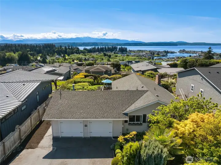 The bird’s-eye view showcases the home’s exceptional setting, capturing the sweeping Hood Canal and Olympic Mountain views, mature gardens, and peaceful surroundings of Driftwood Key. The bird’s-eye view showcases the home’s exceptional setting, capturing the sweeping Hood Canal and Olympic Mountain views, mature gardens, and peaceful surroundings of Driftwood Key.
