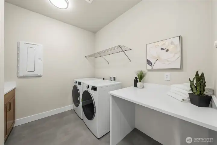 Laundry room with cabinets and sorting table