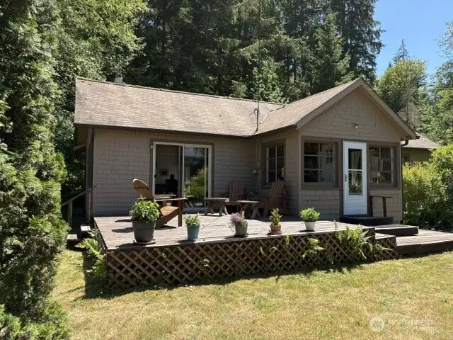 Low profile deck off living room for entertaining and enclosed entry sun room.