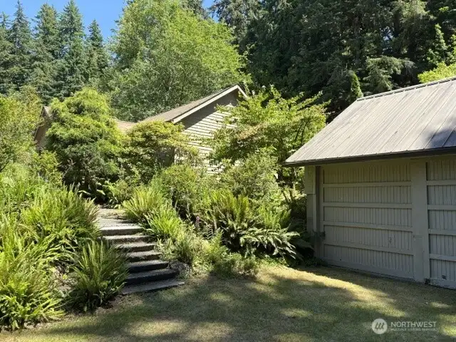 Terraced access from driveway to cabin and detached garage.