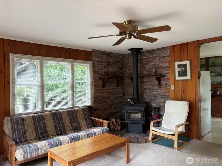 Free standing wood stove with attractive brick surround.