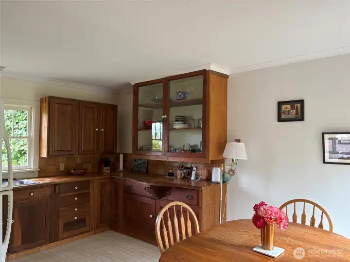 Wood cabinetry and countertops in eat-in-kitchen.