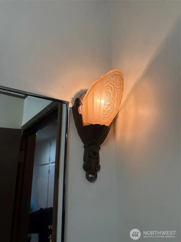 Period lighting sconces in bathroom.