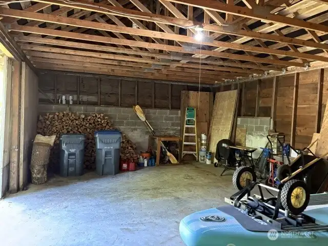 Concrete floor in garage and newer roof trusses.