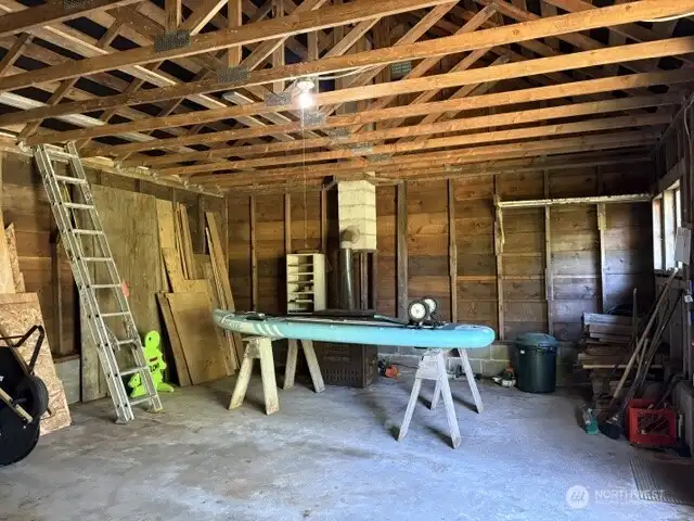 Wood stove in shop area of garage.