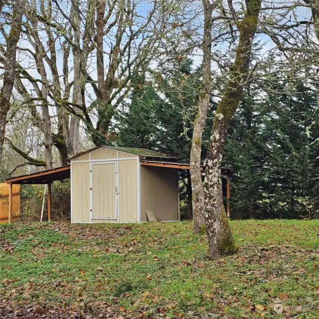 Garden shed with covered parking for mowers or toys