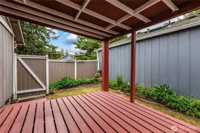 Covered deck ready for a couple chairs and some potted plants.