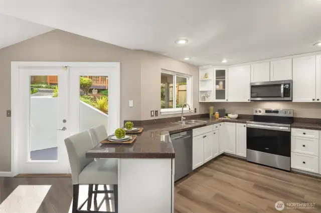 French doors lead to covered outdoor cooking space