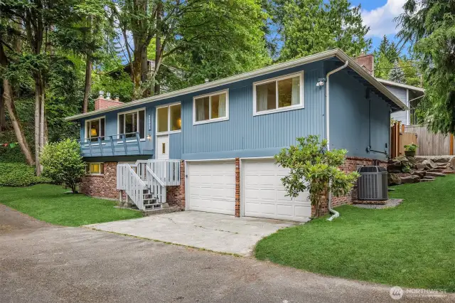Inviting front entry with mature landscaping and curb appeal