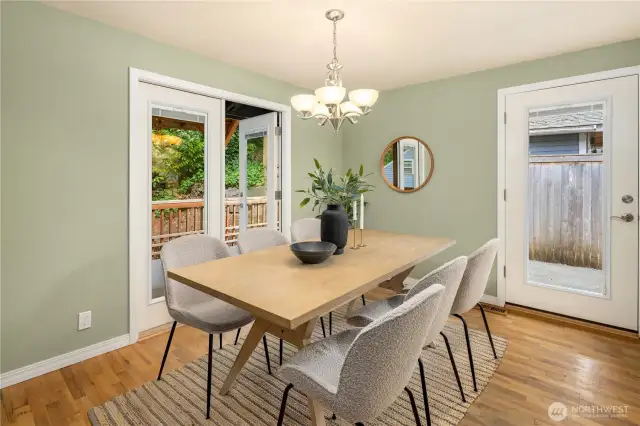 Dining room, open to diningroom, kitchen, patio, and french doors to covered private deck