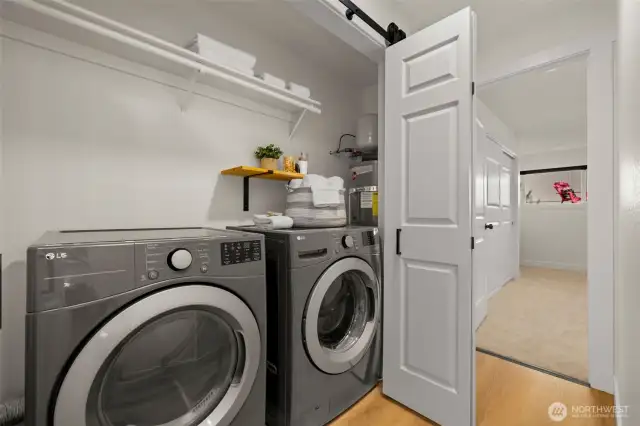 Heading down the hallway is the laundry area; w/d only 2 years old