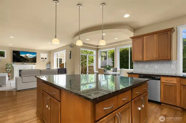 Lots of counter space with this large granite island and breakfast bar.