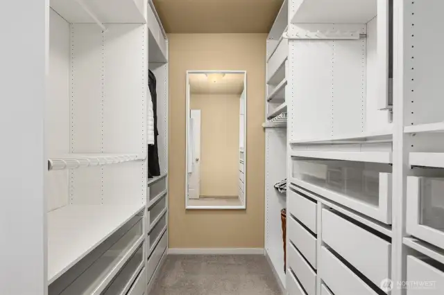 Check out this amazing custom closet!! There is so much great storage here right off the primary bathroom!