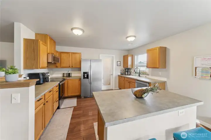 Kitchen w/SS appliances and a pantry/laundry room.