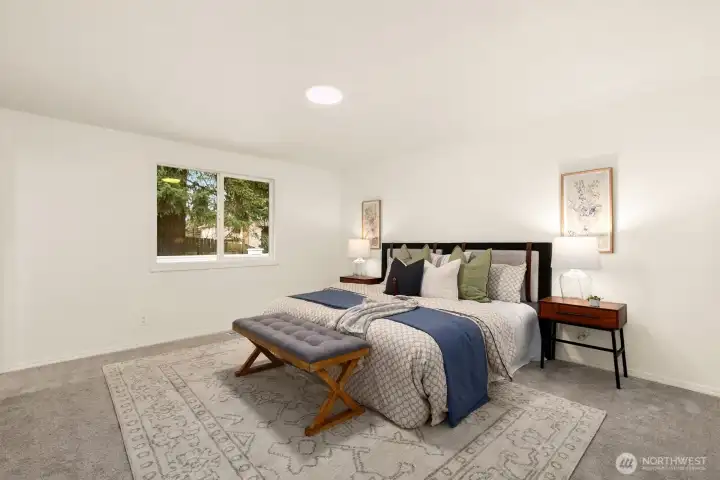 Large primary suite overlooks backyard.