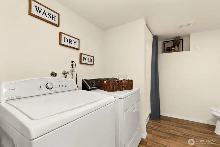 Laundry sits inside lower level bathroom.