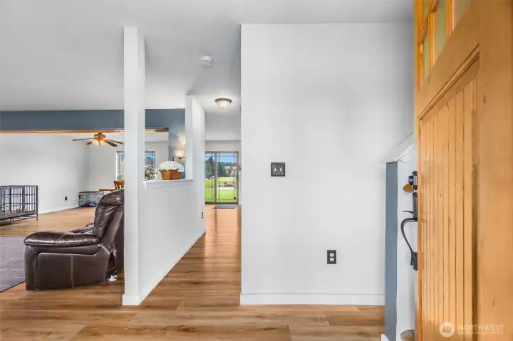 Entry to home. Open concept with wood laminate floors and updated lighting. Lots of windows for extra natural light.