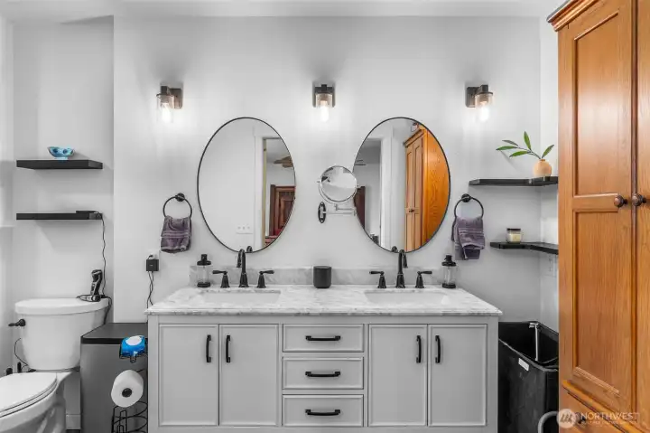 Primary bathroom downstairs has upgraded faucets, sinks, lights ,cabinet and top.