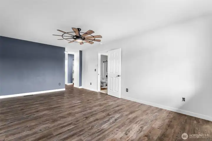 This view is of the primary bedroom upstairs facing entrance ,hall towards adjoining bathroom and walk in closet