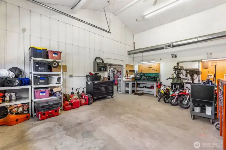 The shop- 200 amp main service. One 100 amp sub panel. Two 50 amp sub panels. Six 30 amp 220 plugs.12 foot eaves. Six inch concrete. Anchor points in slab. Six roll up doors. Four man doors. Ben pak 10,000 pound car/truck hoist.4 ton HVAC unit with spiral ductwork. Bathroom. Utility sink. Hot water. Small refrigerator. Office area. Fiber high speed internet. 4 power cord reels. One air hose reel. RV power plug. 110 plugs everywhere. Large attic space with plywood floor and an alarm system!