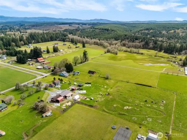 View of pasture, home, shop, run in shelter with power and water, and barn that has $7,000 in materials. Needs to be sided. This barn also has power and water to it.
