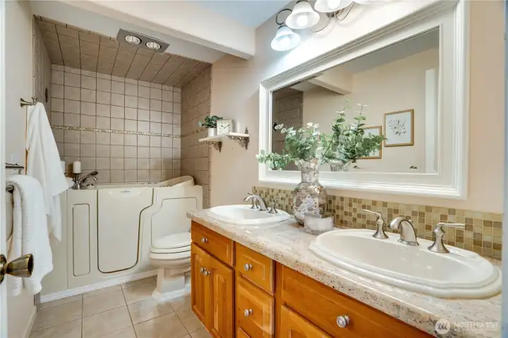 Primary bathroom with a spa-like seated jetted tub