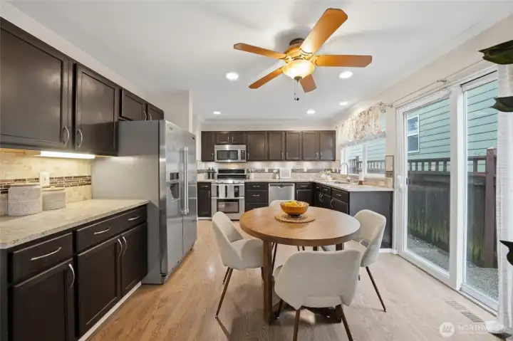 Granite slab countertops, stainless steel appliances, and ample cabinetry.