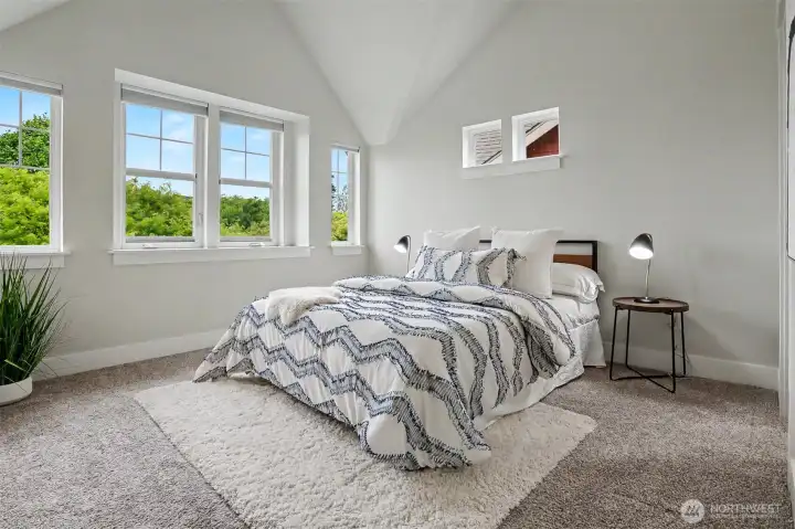 Upstairs is the primary bedroom with vaulted ceilings.