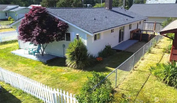 East side back yard with deck and garden area