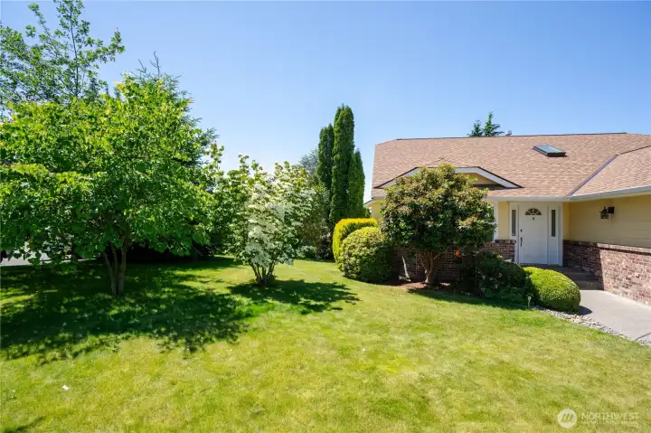 Corner lot, landscaped with beautiful shrubbery and assortment fruit trees and other variety of trees. Partially fenced. Corner lot, landscaped with beautiful shrubbery and assortment fruit trees and other variety of trees. Partially fenced.