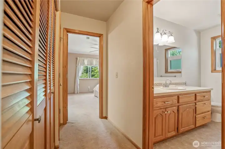 Hallway between the owner suite and 2nd bedroom. Hallway laundry to the left. Washer and dryer are staying Hallway between the owner suite and 2nd bedroom. Hallway laundry to the left. Washer and dryer are staying