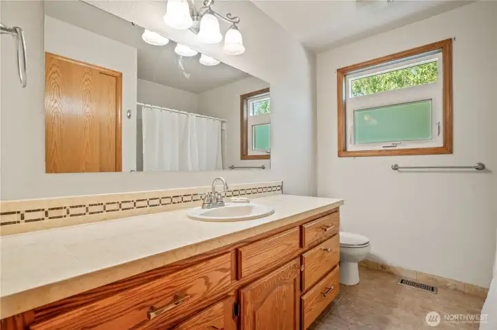 Guest or main level bathroom with tub and shower and backsplash Guest or main level bathroom with tub and shower and backsplash