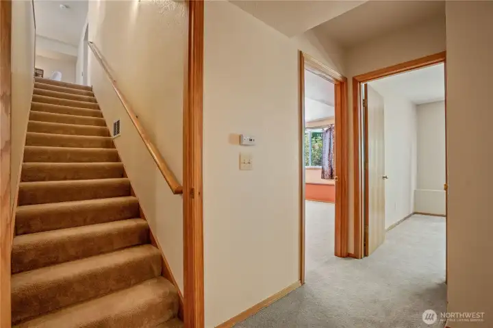 Looking up the stairwell with entertainment room to the right along with 3rd bedroom Looking up the stairwell with entertainment room to the right along with 3rd bedroom