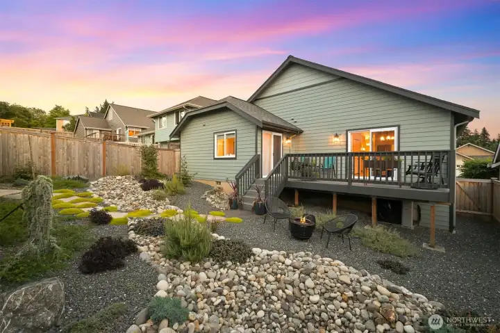 "Dry River" with river rock and drought-resistant plantings. Flagstone path flanked by Scotch Moss leads to back gate "Dry River" with river rock and drought-resistant plantings. Flagstone path flanked by Scotch Moss leads to back gate