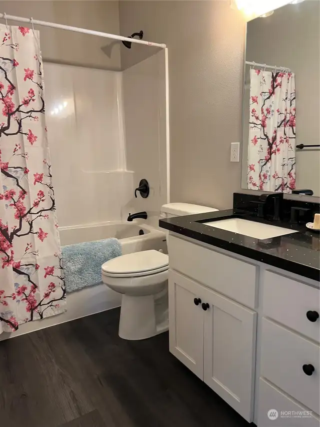 Full bath, off main hallway, shower has never been used. Beautiful granite counter tops, match the kitchen and primary bath.  Soft close drawers and a linen closet.