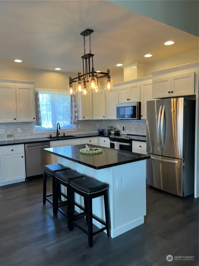 Beautiful kitchen all stainless steel appliances, dishwasher has never been used.  Subway tile back splash, Island has plenty of extra storage room and offers a wonderful eating space.