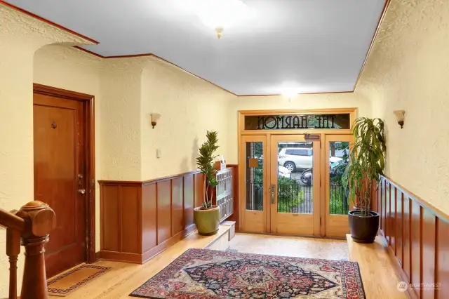 Gorgeous original details preserved in the elegant lobby, with coved ceilings and wall sconces