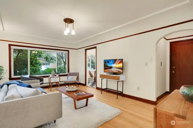 Oversized front window illuminates light throughout, offering views of lush landscaping and nieghborhood