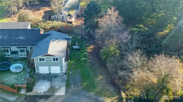 Driveway leads to sidewalk to house