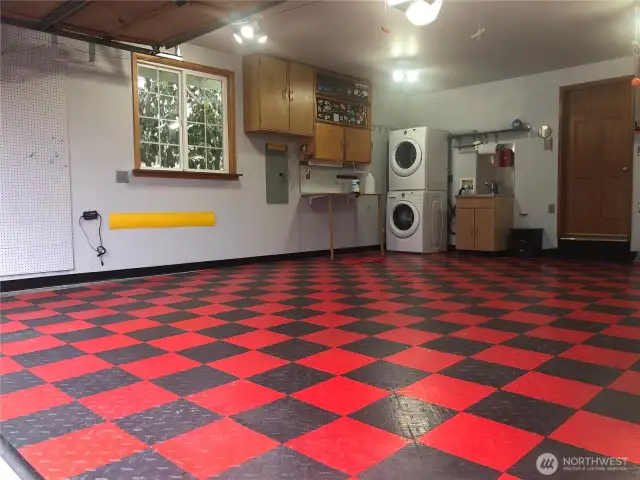 Large double garage w/custom flooring, lots & of storage.