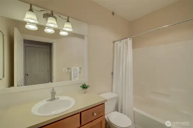 Full bath with a tub/shower combo.