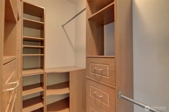 Primary walk-in closet with custom built-ins.