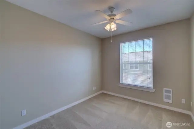 Secondary bedroom with a ceiling fan for added comfort.